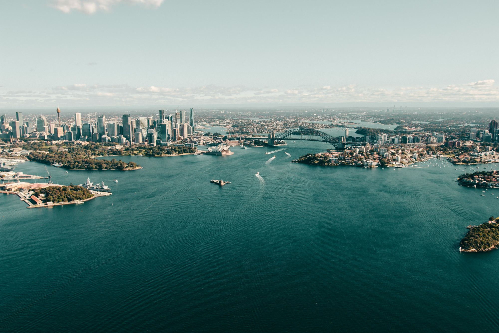 Aerial view of Sydney Harbour, the Opera House, and the Harbour Bridge